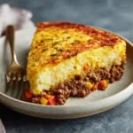 Ground Beef Shepherd’s Pie 3 Slice of ground beef shepherd’s pie showing beef and vegetable filling with creamy mashed potato topping on a plate